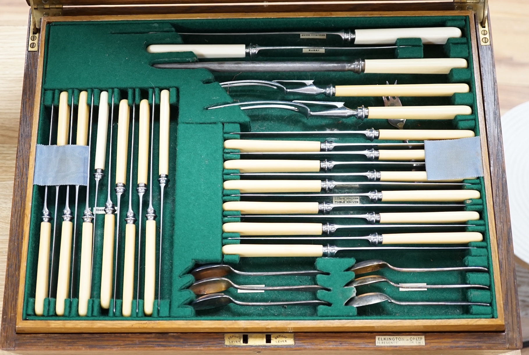An Elkington & Co plated Old English pattern canteen of cutlery, oak cased, 48cm wide. Condition - fair